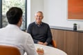 Patient smiling during an All-on-4 dental implant consultation with an oral surgeon