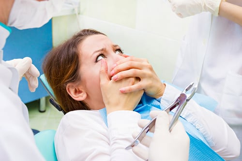 Lady at the dentist with mouth pain