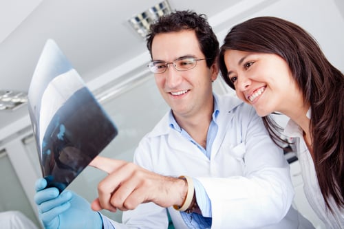 Dentist looking at an x-ray with a patient