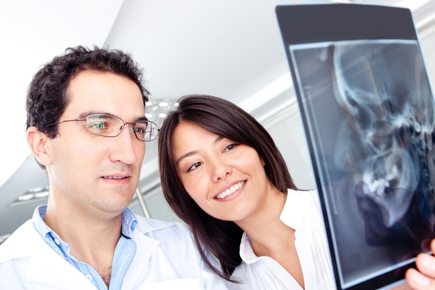 Dentists looking at a cranial x-ray at the hospital