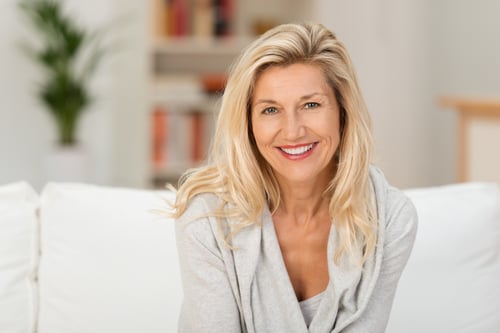 lady sitting on a sofa smiling