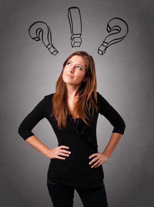 Beautiful young lady thinking with question marks overhead