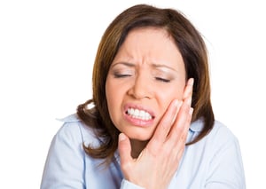 Closeup portrait, mature woman with sensitive tooth ache crown problem about to cry from pain touching outside mouth with hand, isolated white background. Negative emotion facial expression feeling-1