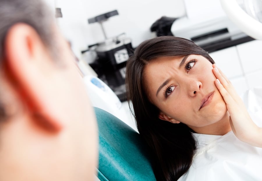 Woman at the dentist complaining about a tooth pain