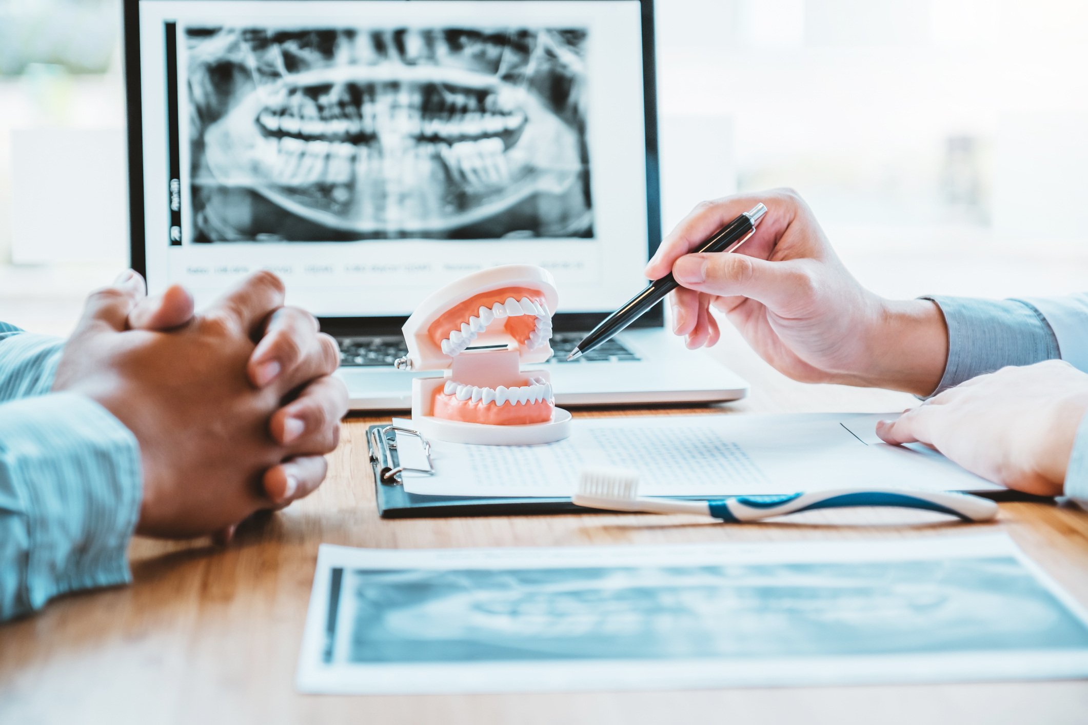 Dentist with patient discussing dental problems