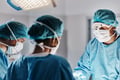 Doctor doing operation wearing face mask for medical procedure 