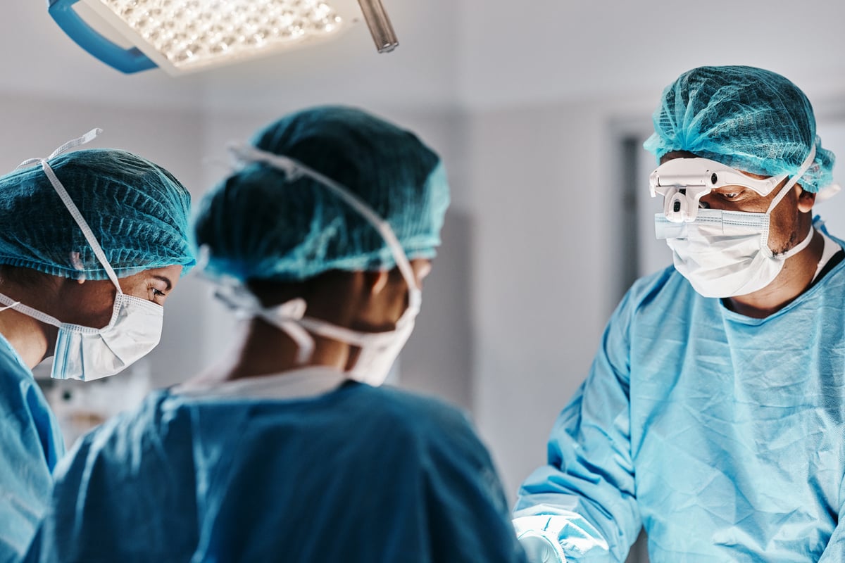 Doctor doing operation wearing face mask for medical procedure 