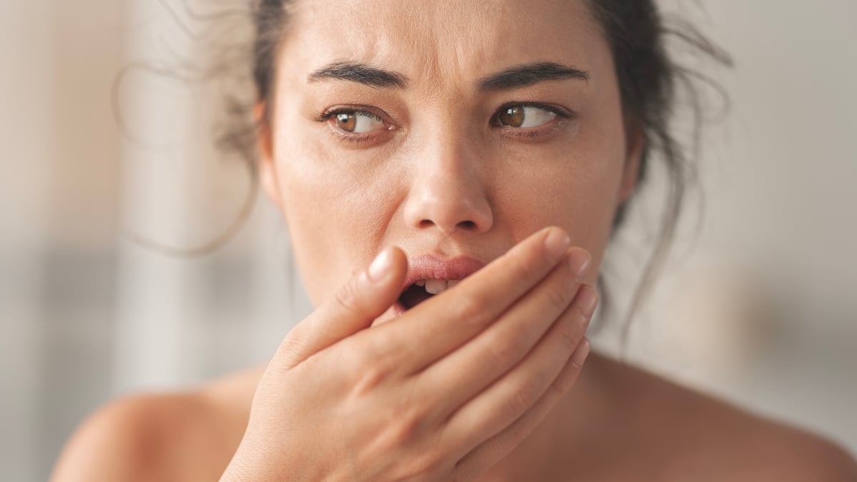 Woman checking the smell of her breath