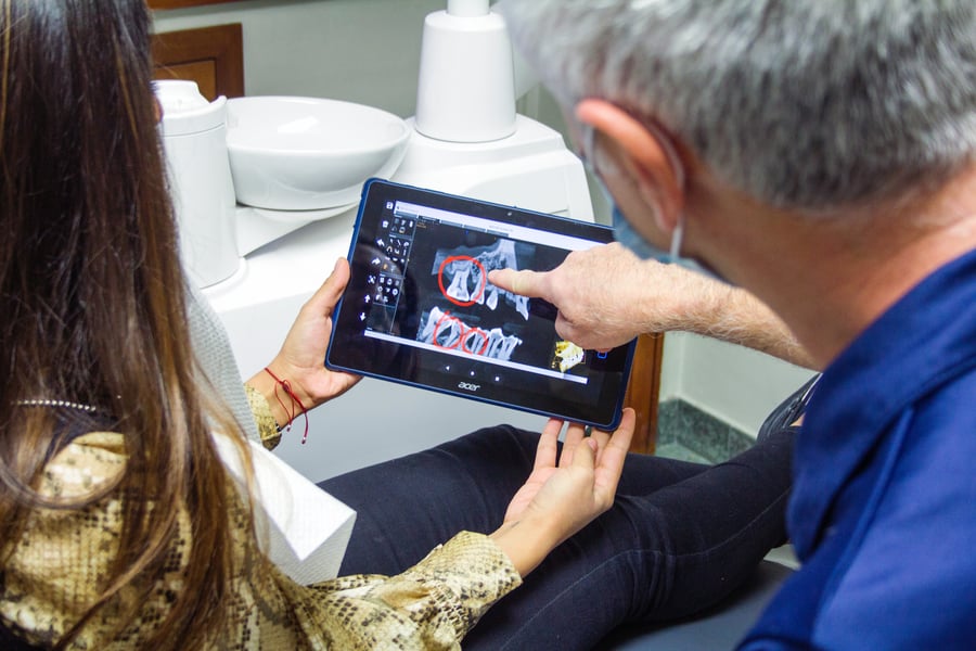 Northwest Oral Surgery Understanding Tooth Extraction Oral Surgeon Looking at X-Ray