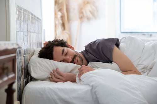 Man sleeping in a bed