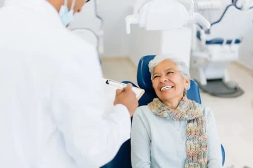 senior citizen woman smiling at her dentist