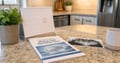 Wisdom teeth removal guide, dental X-ray, and appointment calendar on a kitchen countertop for planning a teen’s oral surgery.