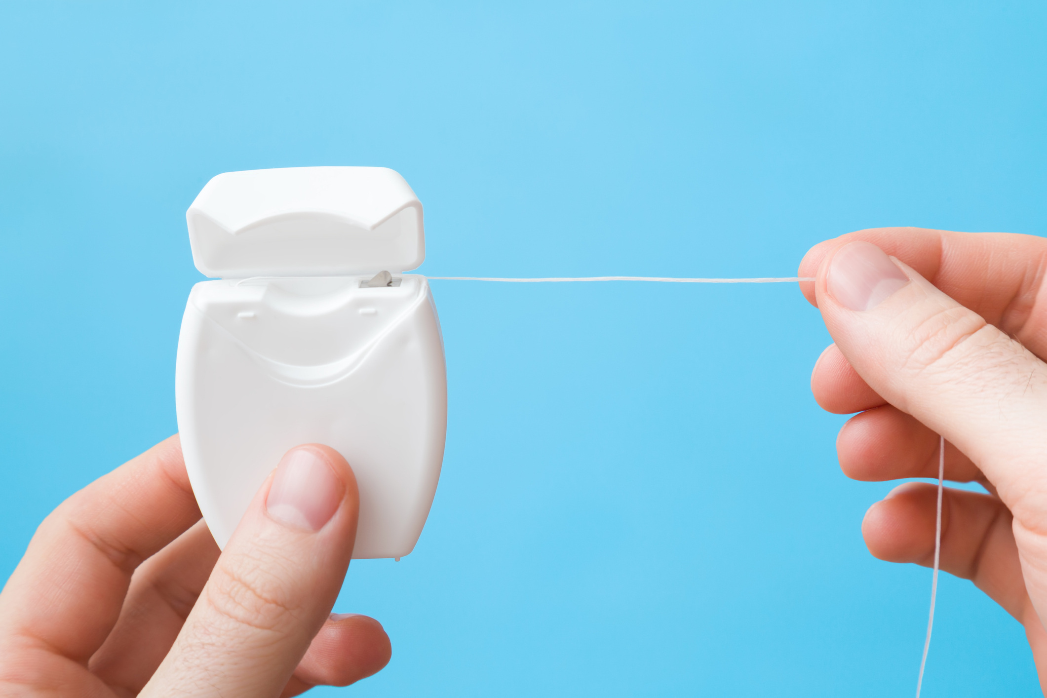 Hands holding floss